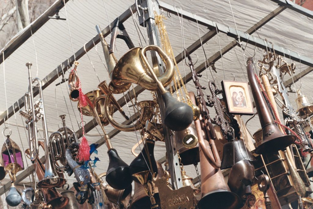 various instruments hanging from a stall in the street market El Rastro