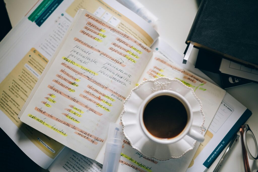 Image of a coffe and a book with Spanish grammar