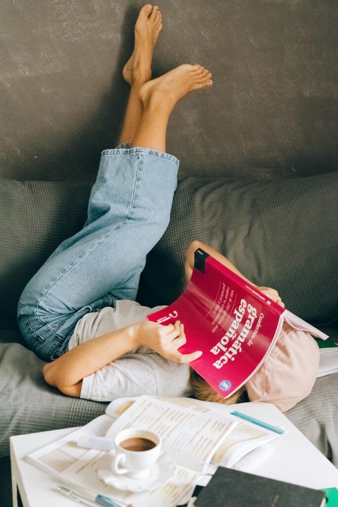 woman on a sofa learning Spanish